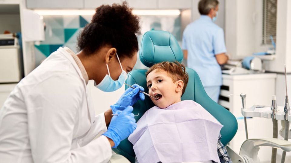 Dentist Examining Kid's Teeth