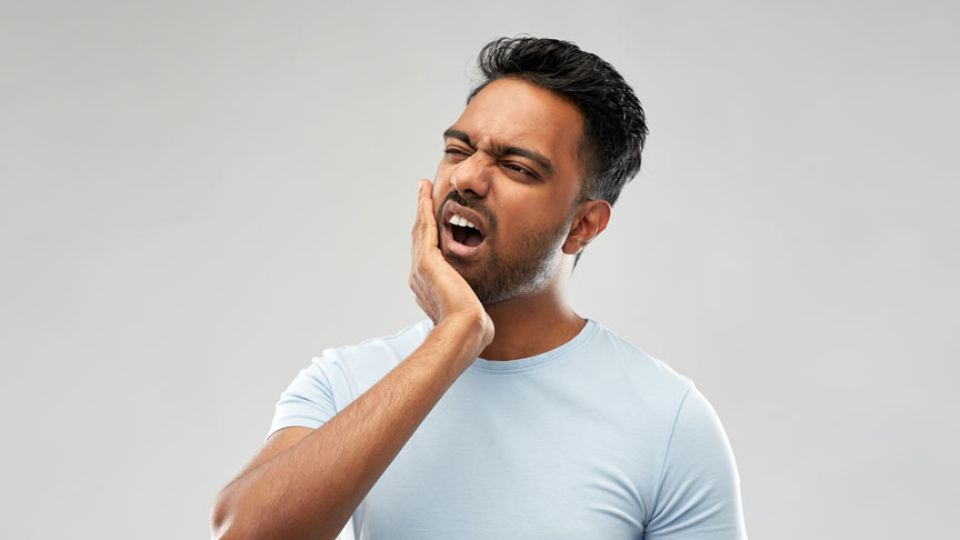 Man Holding His Jaw In Pain Due To A Toothache