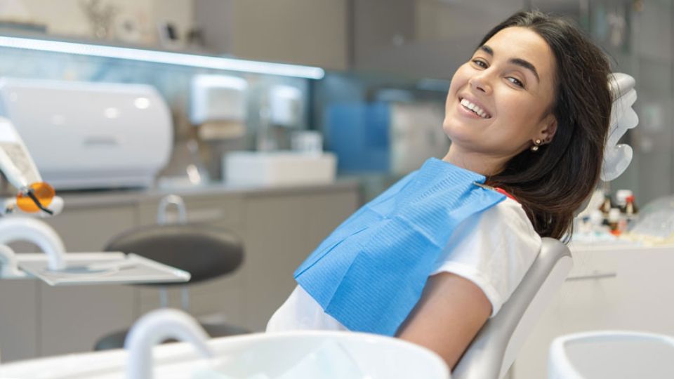 Woman Sitting On A Dental Chair And Smiling
