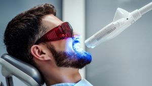 Patient Getting Teeth Whitening Treatment At Dental Clinic
